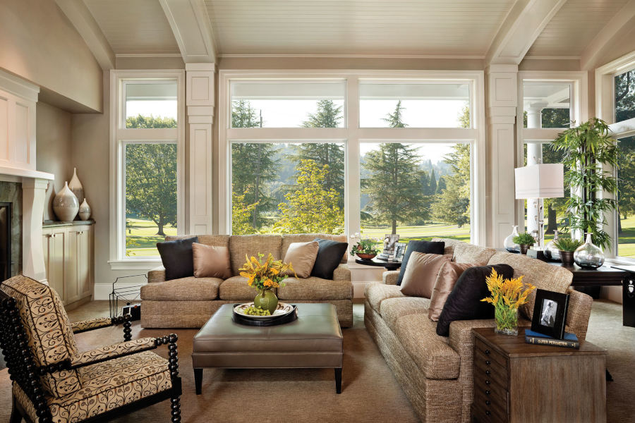 A New Hampshire living room with large replacement windows looking onto the yard